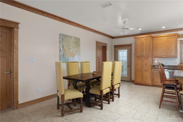 dining room featuring ceiling fan, light tile patterned floors, and crown molding