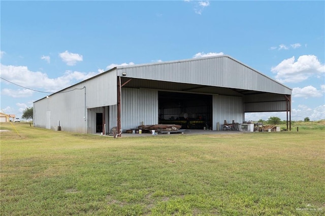 view of outbuilding featuring a lawn