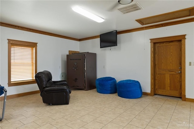 living area with crown molding