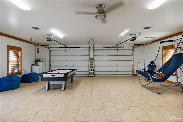 garage featuring ceiling fan and a garage door opener