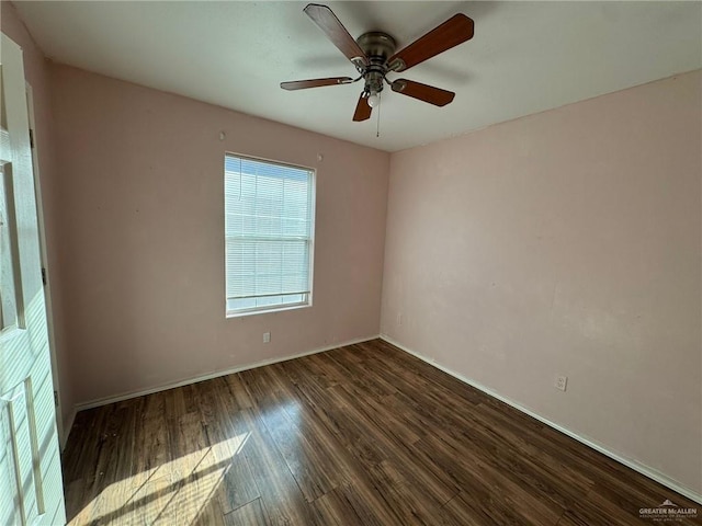 empty room with ceiling fan and dark hardwood / wood-style flooring