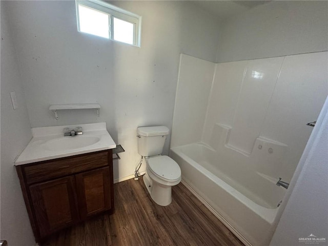 bathroom featuring vanity, wood-type flooring, and toilet