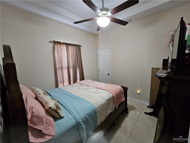 tiled bedroom featuring ceiling fan