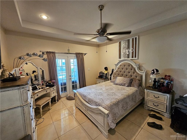 tiled bedroom with access to outside, a raised ceiling, ceiling fan, and french doors