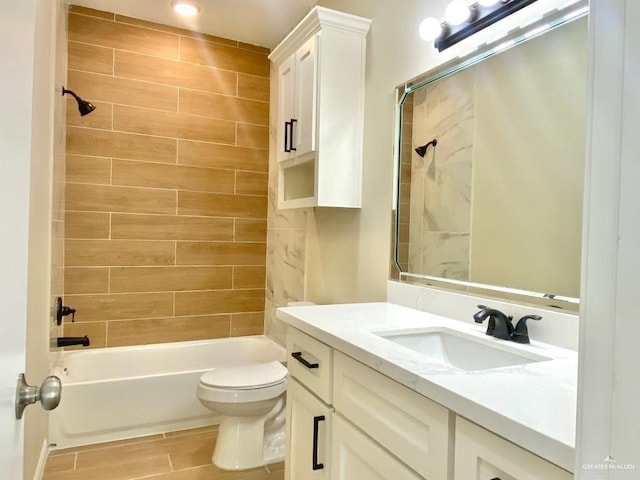 bathroom with vanity, shower / tub combination, wood finish floors, and toilet