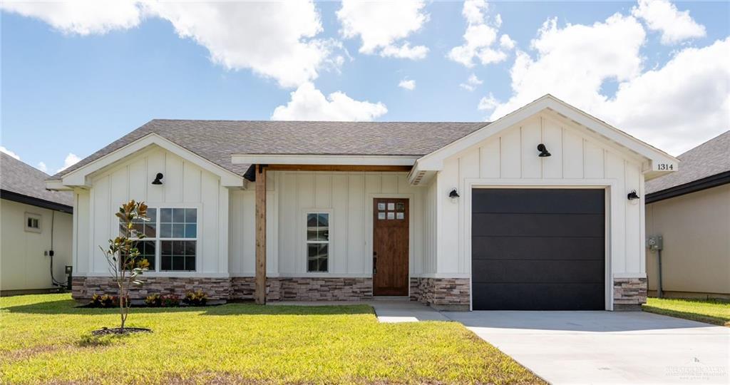 modern farmhouse style home with a garage and a front yard