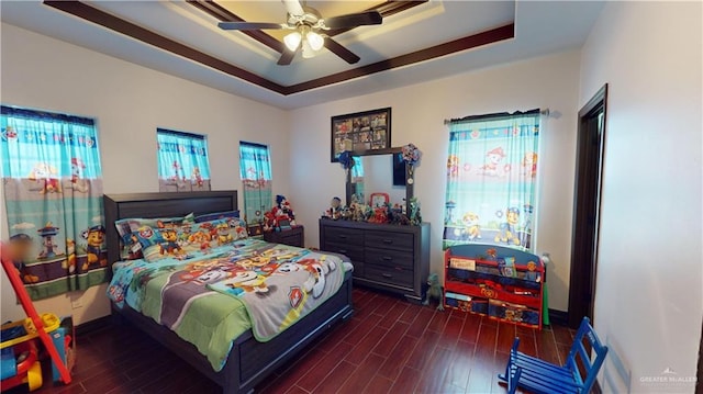 5403 Mauritius Ln, Edinburg, TX 78542 - bedroom featuring a tray ceiling, baseboards, a ceiling fan, and wood finished floors