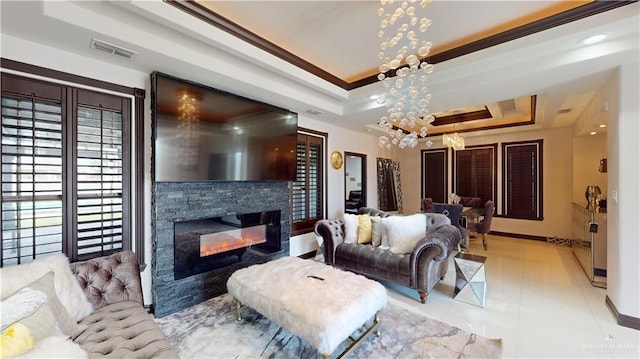 5403 Mauritius Ln, Edinburg, TX 78542 - living area with a tray ceiling, a notable chandelier, visible vents, a stone fireplace, and light tile patterned flooring