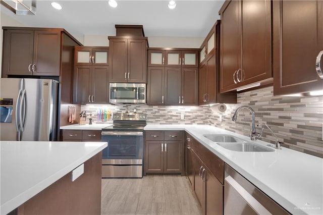 4001 Santa Erica St, Mission, TX 78572 - kitchen with stainless steel appliances, a sink, light countertops, backsplash, and recessed lighting