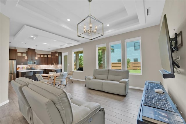 4001 Santa Erica St, Mission, TX 78572 - living area featuring a raised ceiling, a chandelier, baseboards, wood finish floors, and recessed lighting