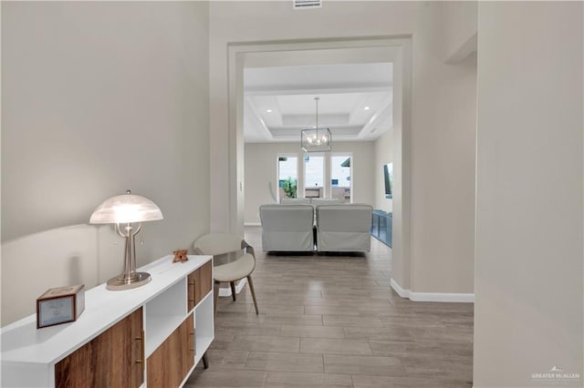 4001 Santa Erica St, Mission, TX 78572 - corridor with a tray ceiling, a chandelier, light wood-style floors, recessed lighting, and baseboards