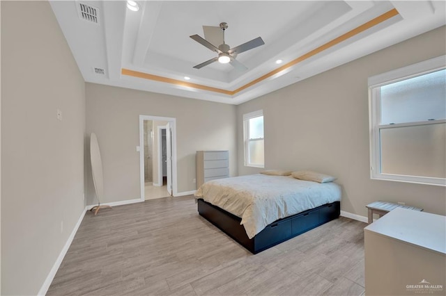 4001 Santa Erica St, Mission, TX 78572 - bedroom with a tray ceiling, recessed lighting, baseboards, light wood-style flooring, and connected bathroom