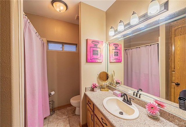 bathroom featuring tile patterned floors, vanity, and toilet