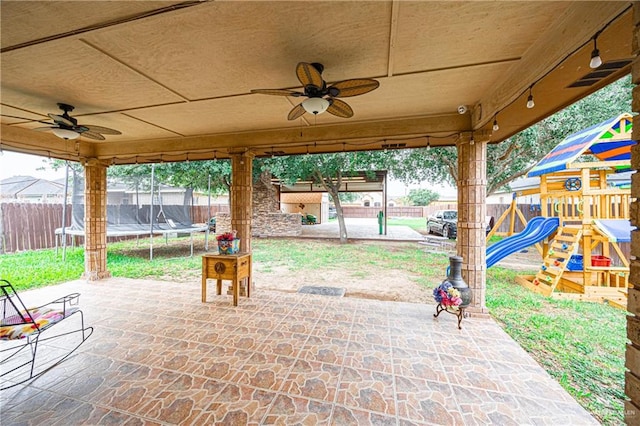 view of patio / terrace featuring a trampoline, ceiling fan, and a playground