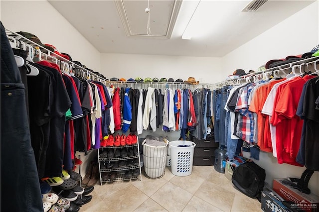 spacious closet with tile patterned floors