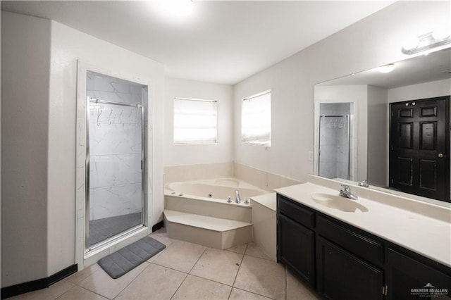 bathroom featuring shower with separate bathtub, vanity, and tile patterned floors