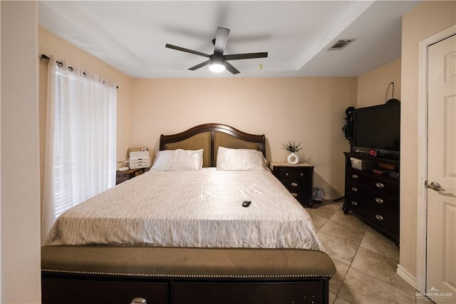 tiled bedroom featuring ceiling fan and multiple windows