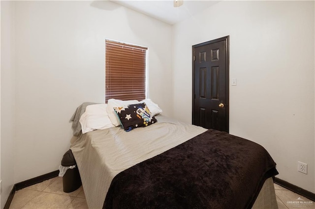 bedroom with ceiling fan and light tile patterned flooring