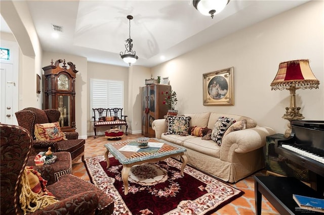 living room featuring a raised ceiling