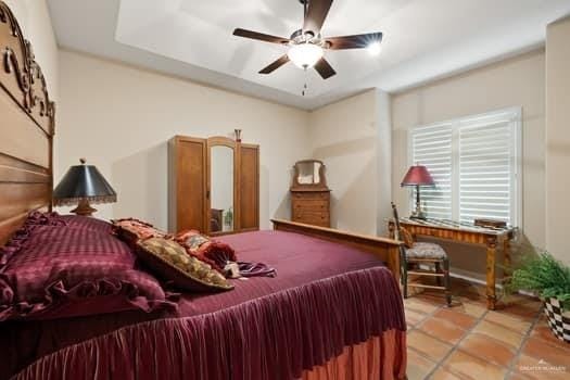 bedroom featuring ceiling fan and light tile patterned flooring