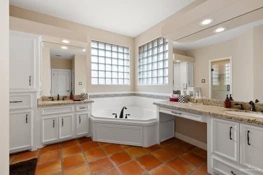 bathroom featuring vanity, a tub to relax in, and tile patterned floors