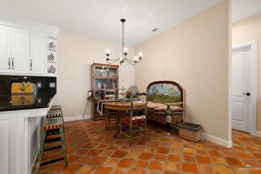 dining space featuring tile patterned flooring and a notable chandelier