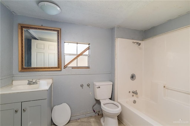 bathroom featuring tub / shower combination, a textured ceiling, toilet, and vanity