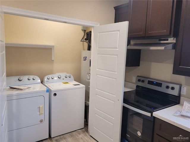 laundry room featuring light hardwood / wood-style flooring and washing machine and clothes dryer