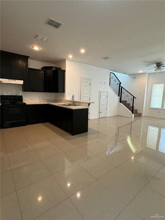 kitchen featuring ceiling fan, sink, black range with electric cooktop, kitchen peninsula, and light tile patterned flooring