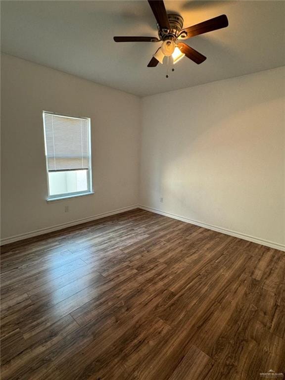 empty room with ceiling fan and dark wood-type flooring