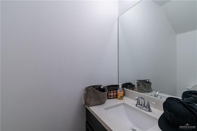 bathroom with vanity and vaulted ceiling