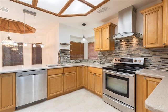 409 Kiwi Ave, Mcallen, TX 78504 - kitchen featuring stainless steel appliances, wall chimney exhaust hood, a sink, hanging light fixtures, and tasteful backsplash