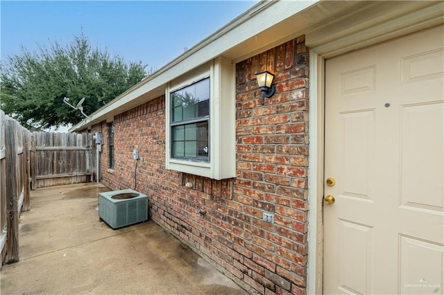 doorway to property with a patio area and cooling unit