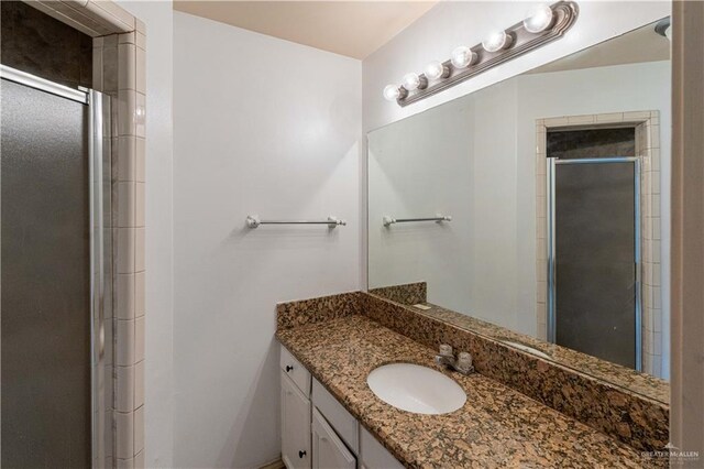 bathroom featuring vanity and an enclosed shower