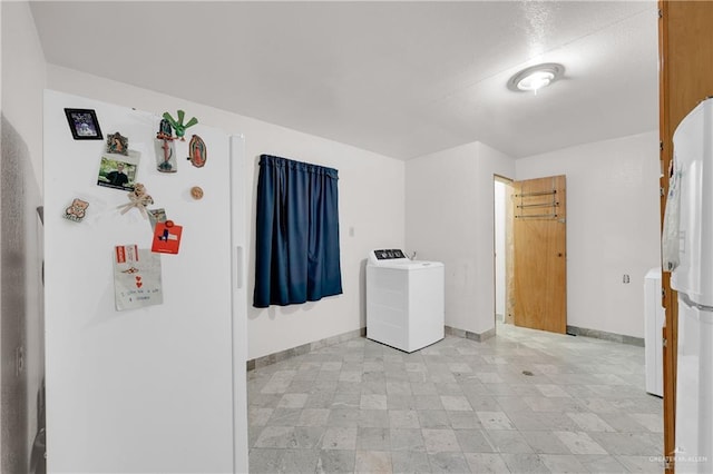 washroom with washer / dryer