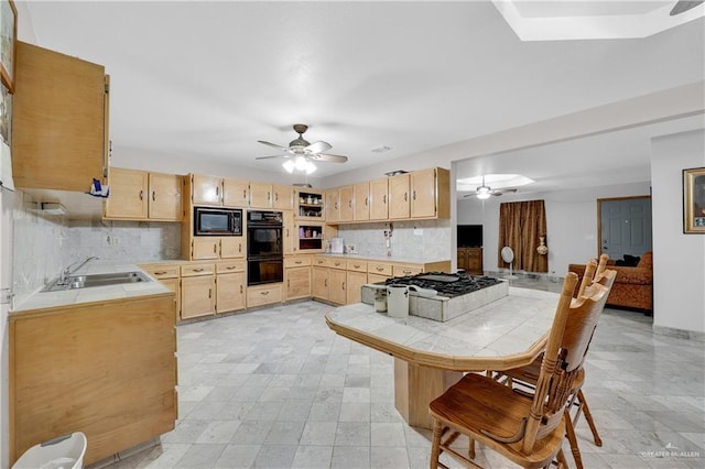 kitchen with tile counters, sink, backsplash, light brown cabinetry, and black appliances