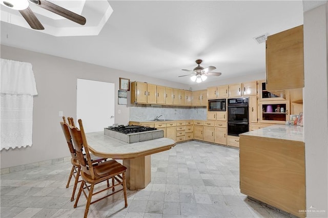 kitchen featuring black appliances, light brown cabinets, and sink