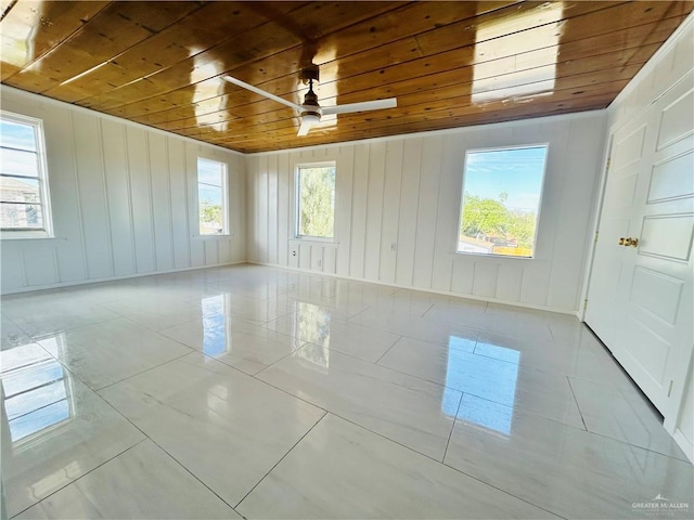 empty room featuring wood ceiling, ceiling fan, and light tile patterned floors