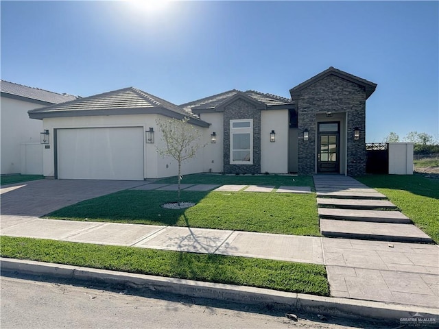 view of front of home featuring a garage, concrete driveway, a front lawn, and stucco siding