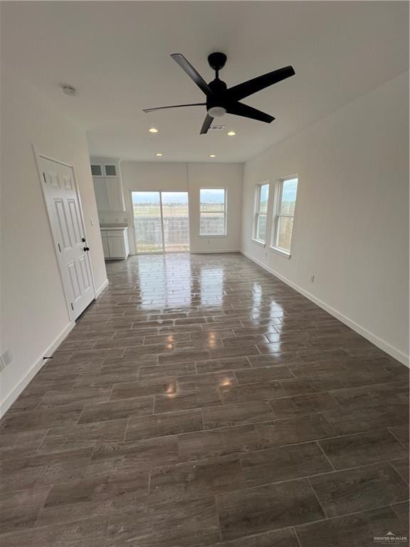 spare room featuring a ceiling fan, baseboards, dark wood-style flooring, and recessed lighting