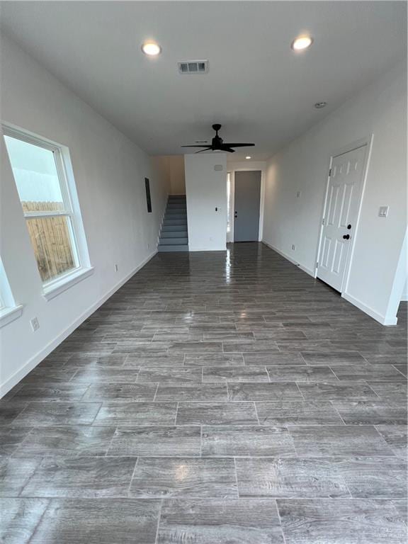 unfurnished living room with recessed lighting, visible vents, ceiling fan, wood finished floors, and stairs