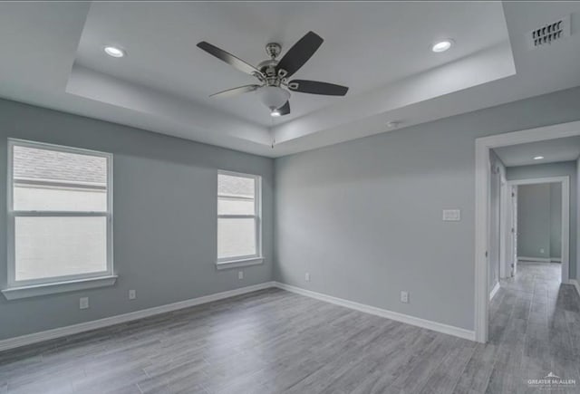 3708 Climax Dr, Edinburg, TX 78542 - spare room featuring a tray ceiling, wood finished floors, ceiling fan, and recessed lighting