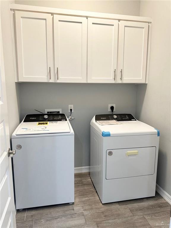 3708 Climax Dr, Edinburg, TX 78542 - laundry area featuring washer and dryer, cabinet space, and light wood-type flooring