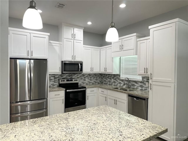 3708 Climax Dr, Edinburg, TX 78542 - kitchen with appliances with stainless steel finishes, white cabinetry, tasteful backsplash, light stone countertops, and recessed lighting