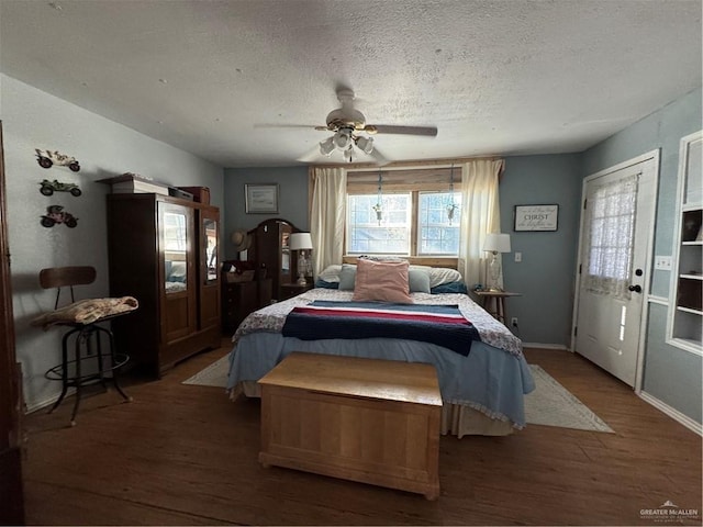 bedroom featuring ceiling fan, hardwood / wood-style floors, and a textured ceiling