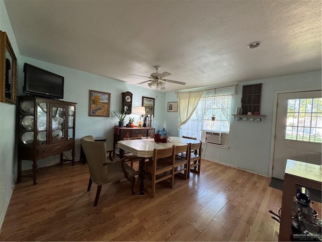 dining space with hardwood / wood-style flooring, ceiling fan, and cooling unit