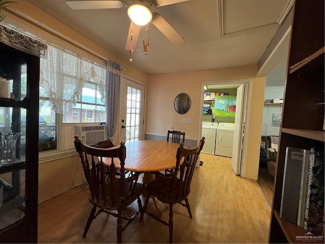 dining area with ceiling fan, light hardwood / wood-style floors, separate washer and dryer, and cooling unit