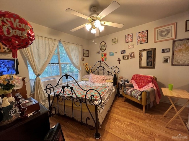 bedroom with light hardwood / wood-style floors and ceiling fan