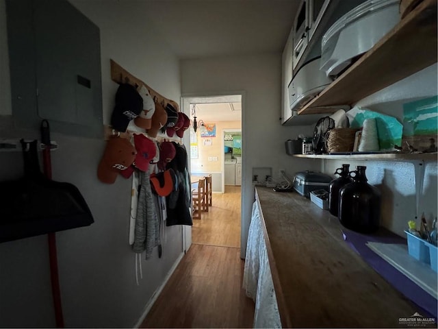 kitchen featuring hardwood / wood-style flooring and washing machine and clothes dryer