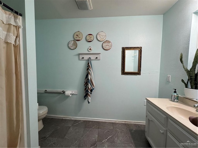 bathroom with vanity and toilet